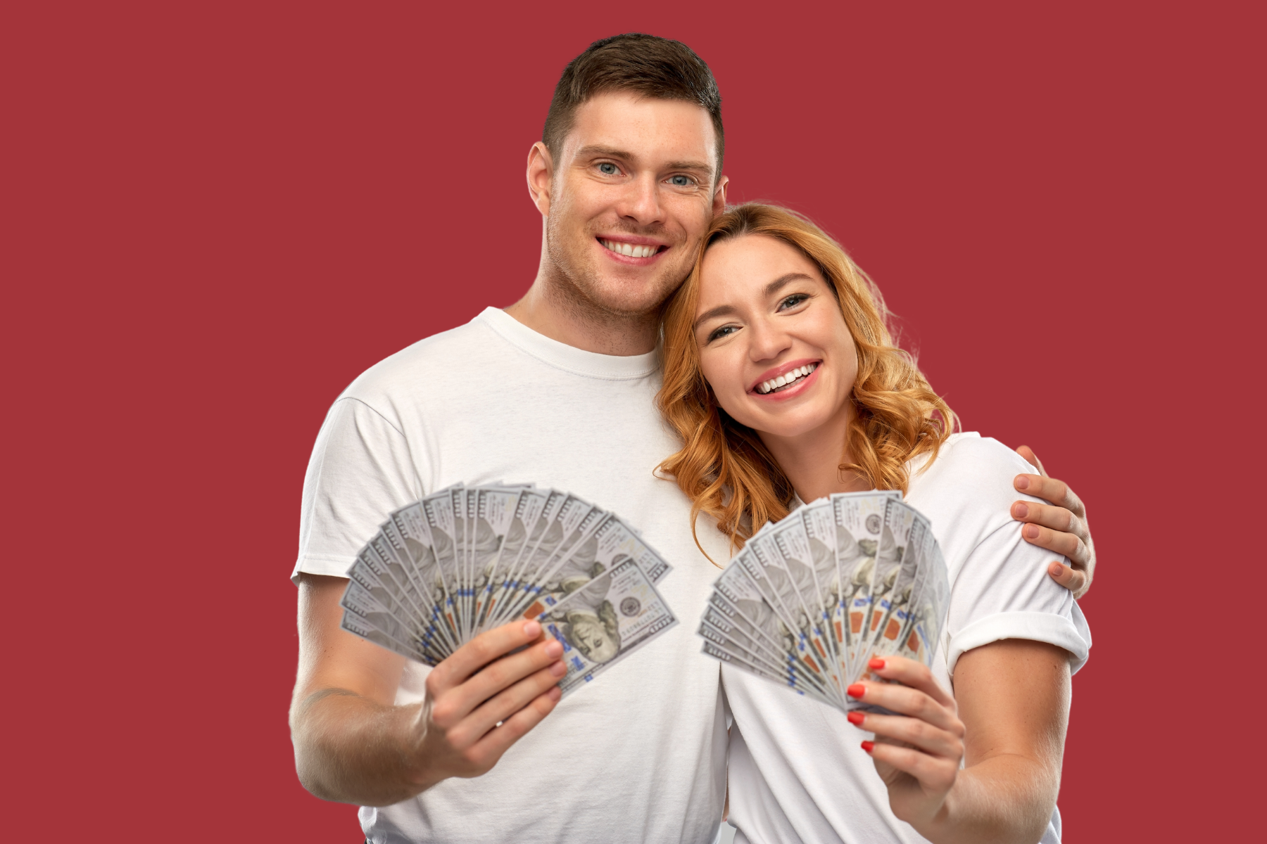 Young couple holding cash and smiling while hugging