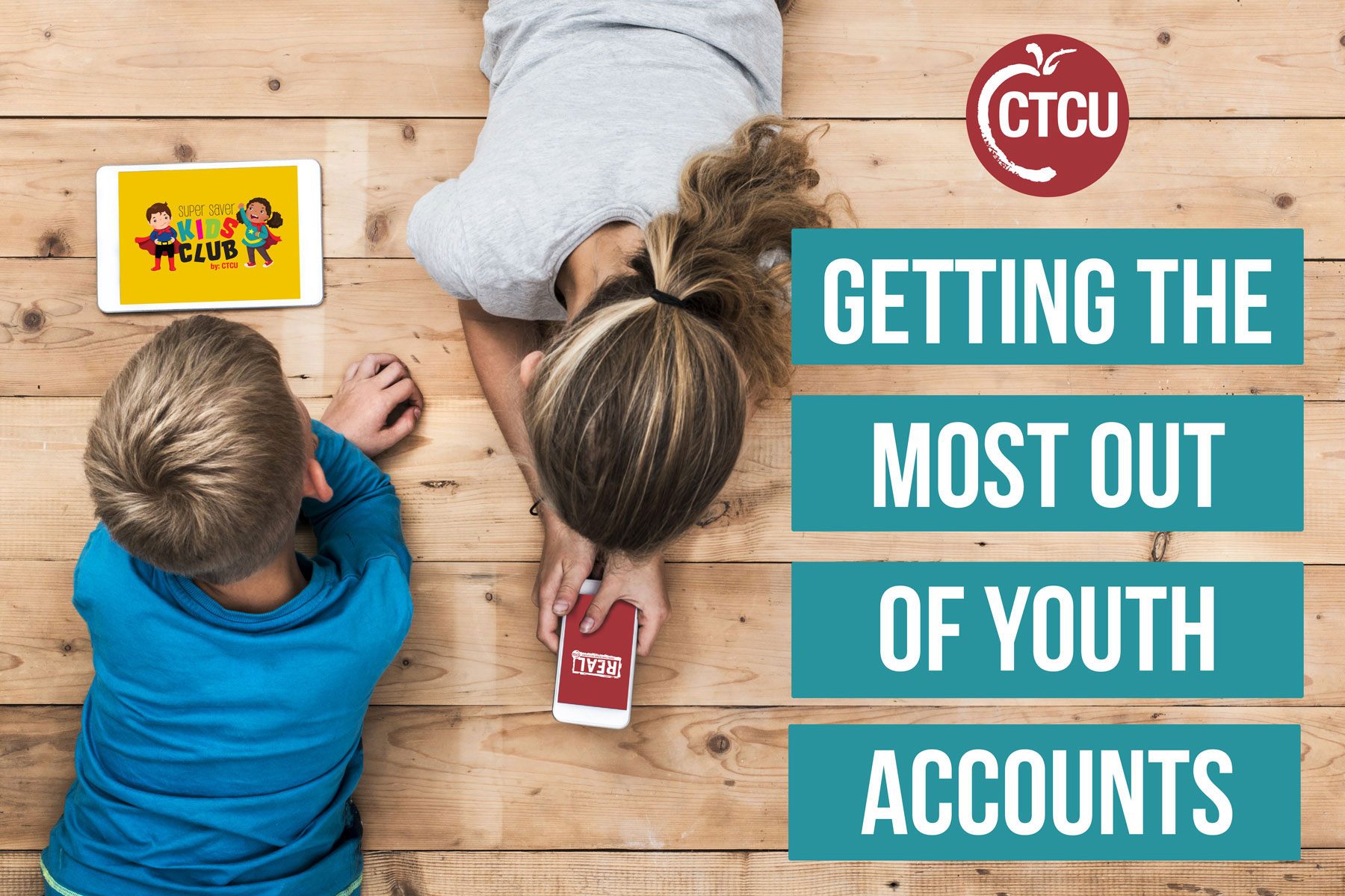 Kids laying on the floor looking at a phone and a tablet device