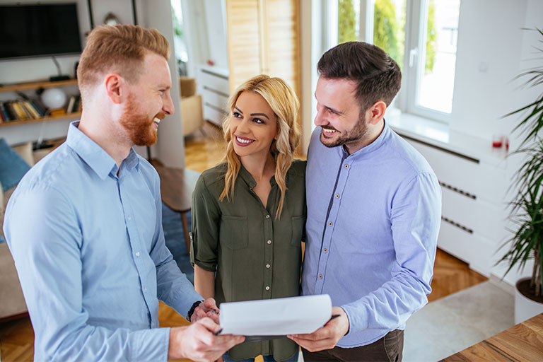 Man and woman discussed mortgage agreement with another man inside a home